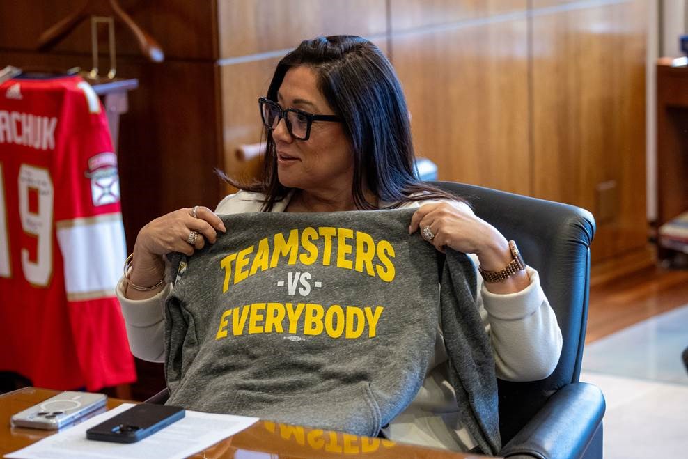 U.S Department of Labor (DOL) Sec. Lori Chavez-DeRemer holding up a t-shirt that says "Teamsters vs. Everybody"